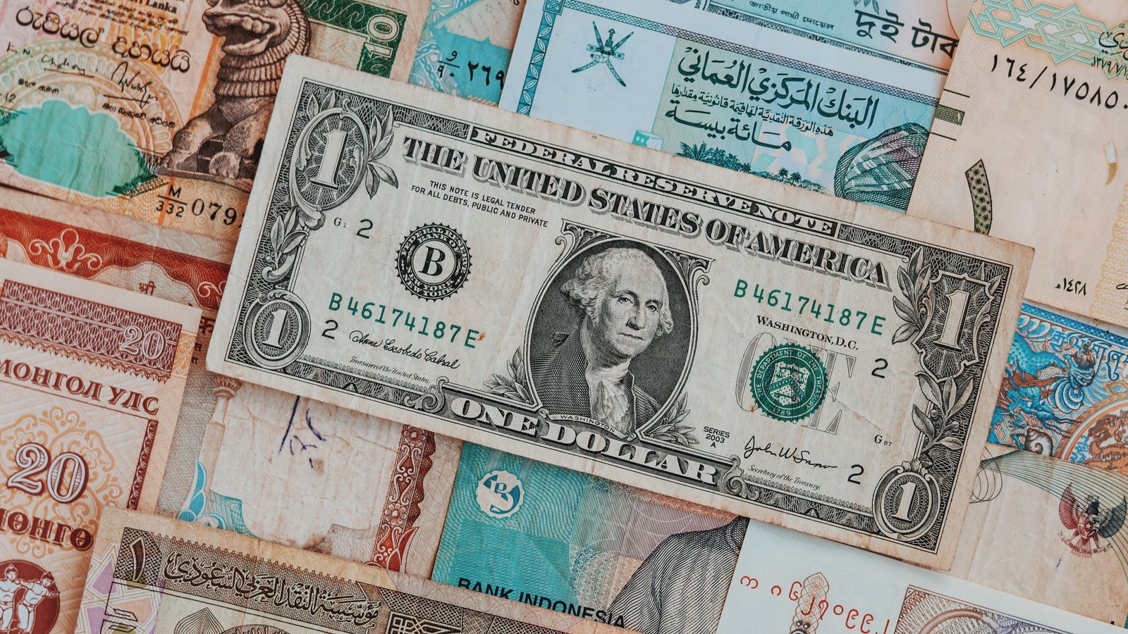 Banknotes from several different countries laid out side by side
