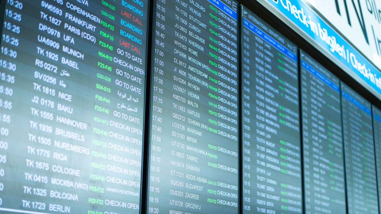 Airport departure board listing flights and times