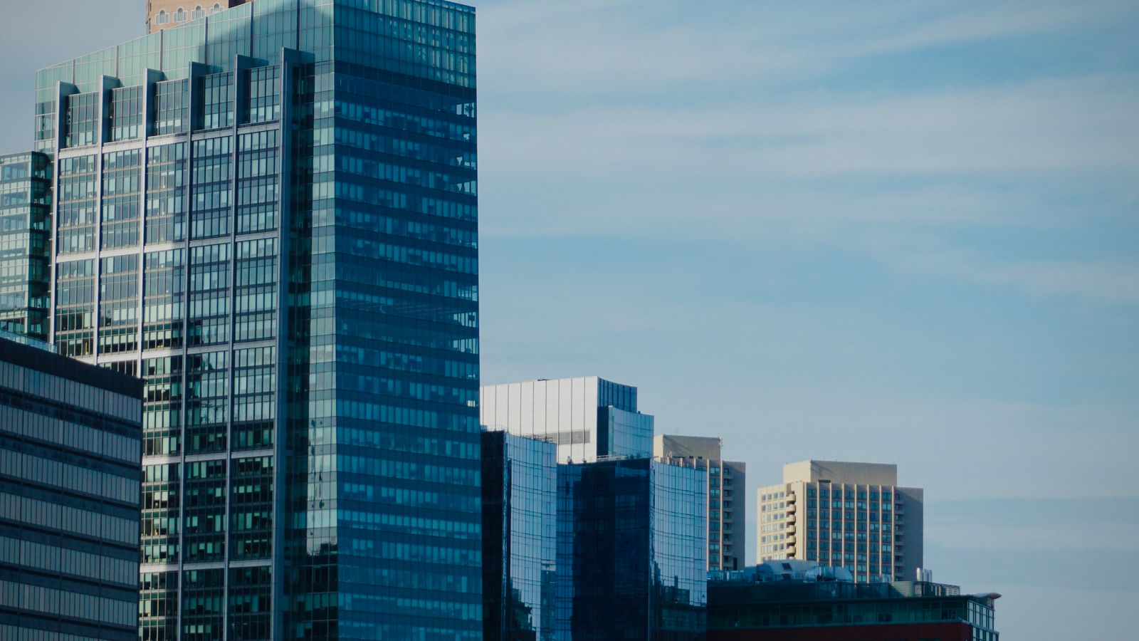 Glass office towers of a corporate district against a clear sky