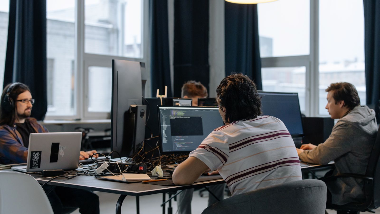 Software developers working together at their computers in an office