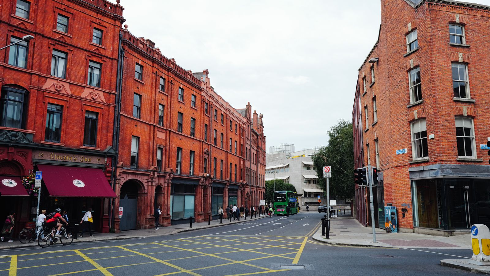 Red-brick city street in Dublin, Ireland with a bus passing
