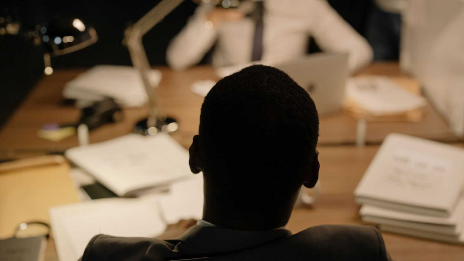 Back view of a person sitting in on a business meeting