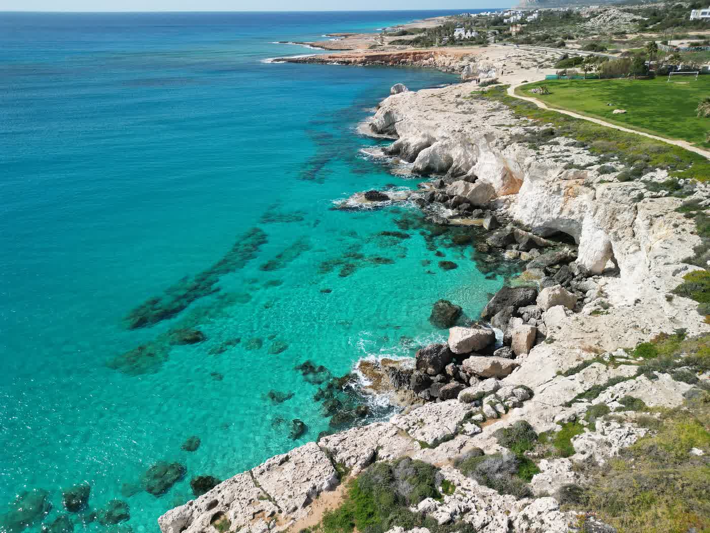 Clear turquoise water off the white limestone cliffs at Cape Greco, the seabed visible through it