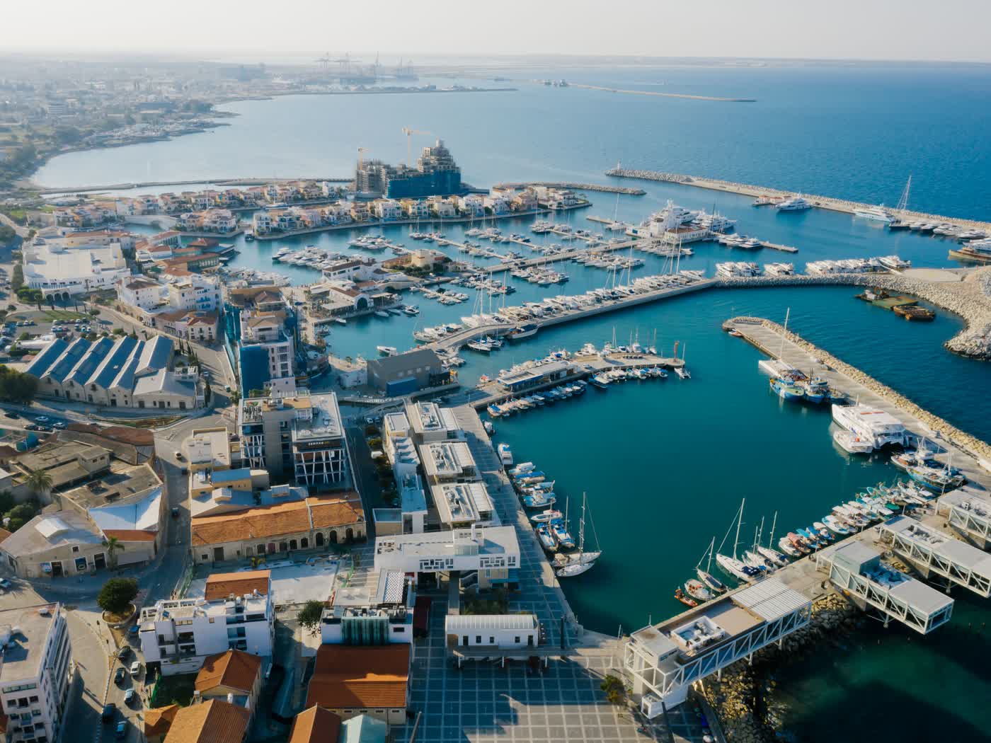 Limassol marina from the air, yachts on every pontoon and the old town running back from the waterfront