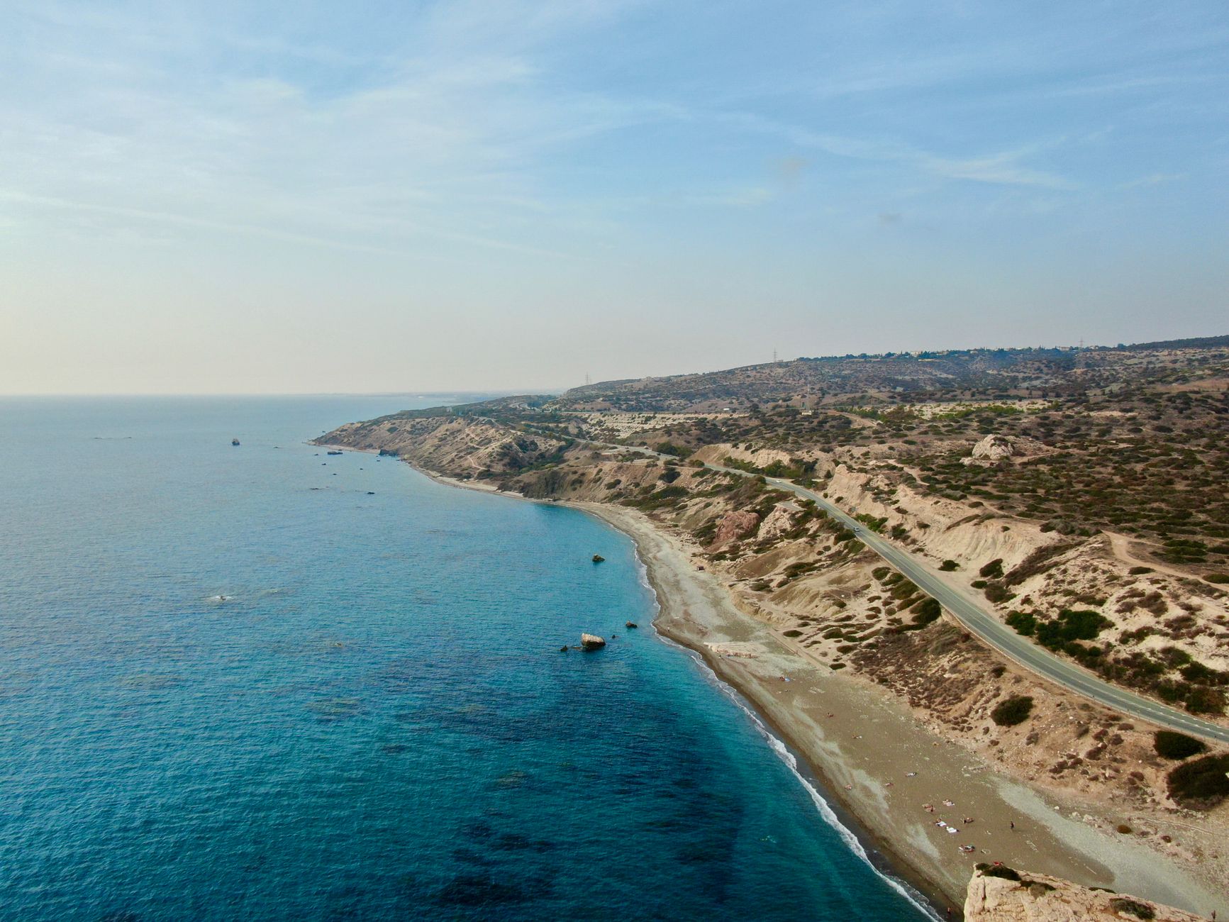 Aerial view of the Kouklia coast in Cyprus, with deep blue sea meeting a rocky shoreline